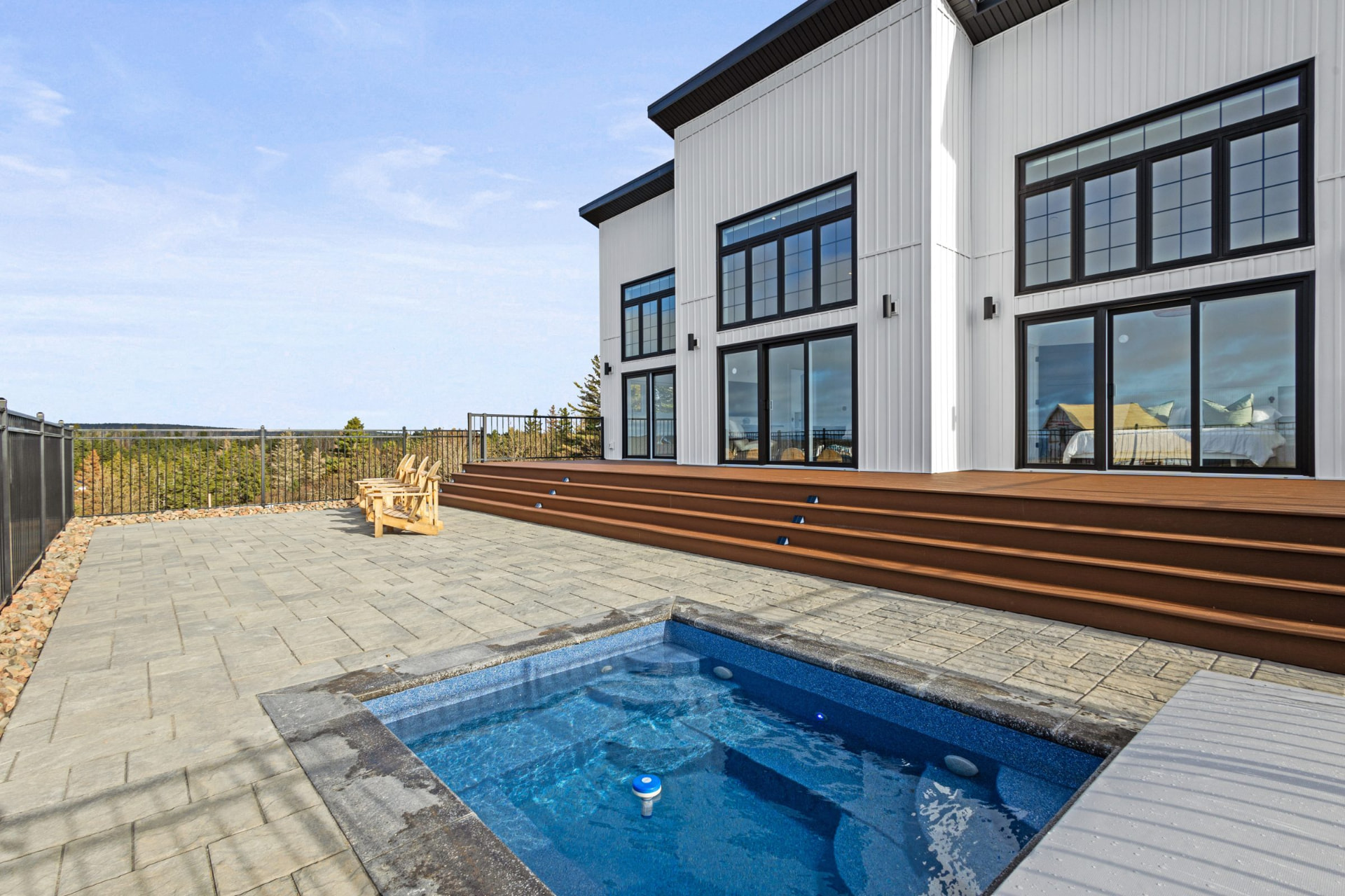 Four-season heated swim spa on the deck with sea views