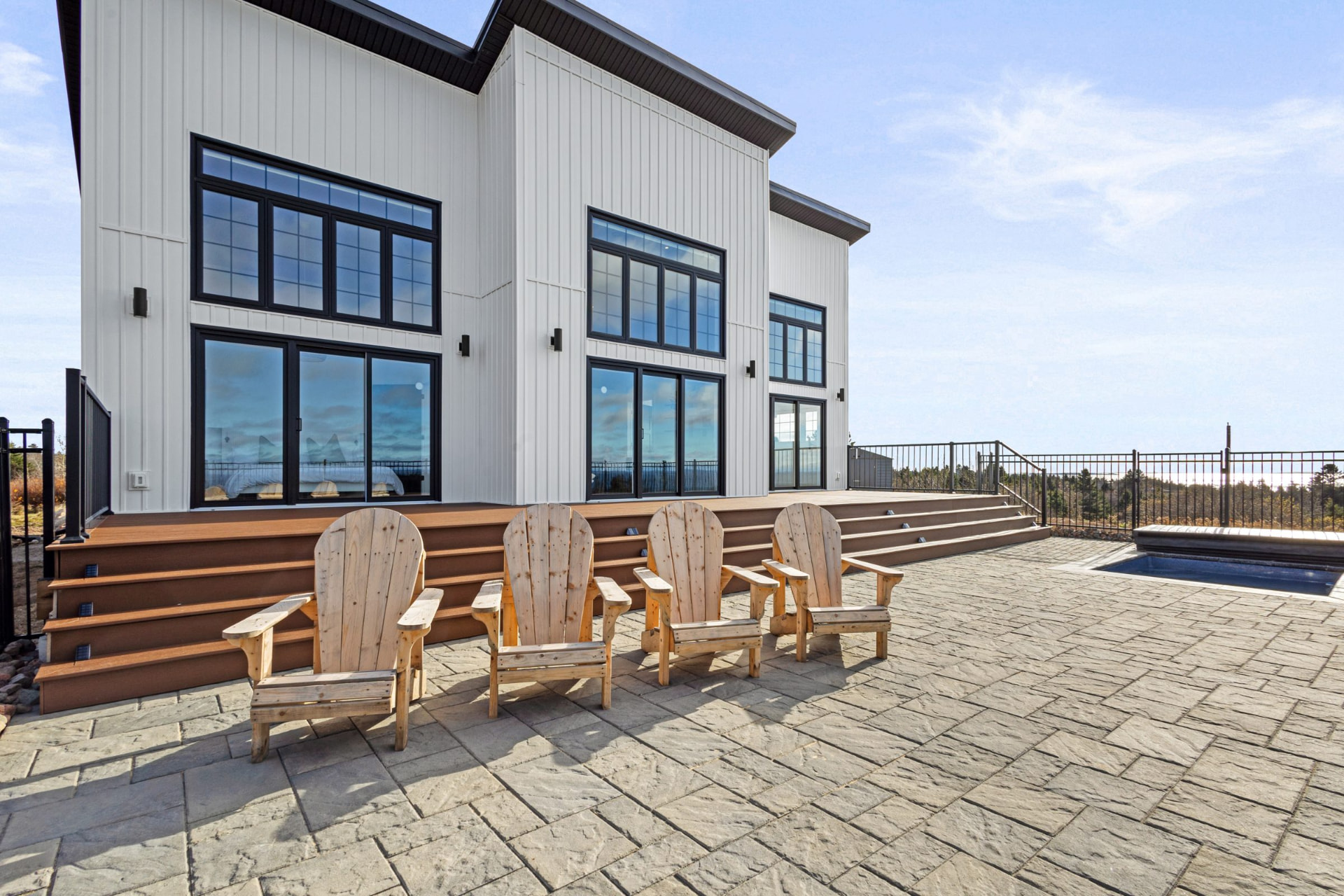 Back of the house with its wide deck overlooking the lawn and the Atlantic