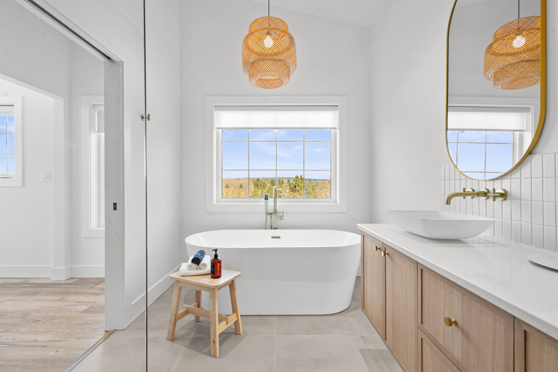 Suite bathroom with a freestanding soaking tub beside a window